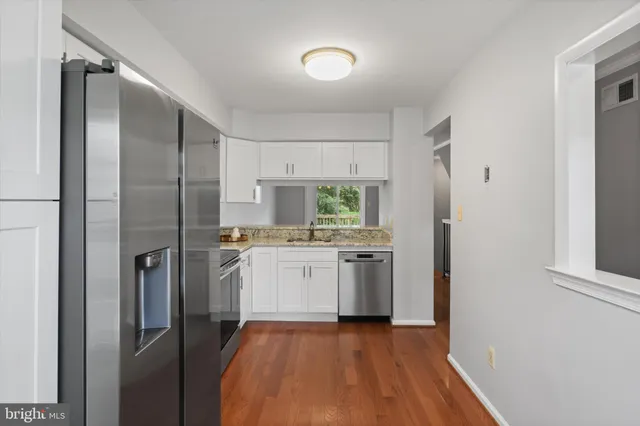a kitchen with stainless steel appliances a refrigerator and a stove