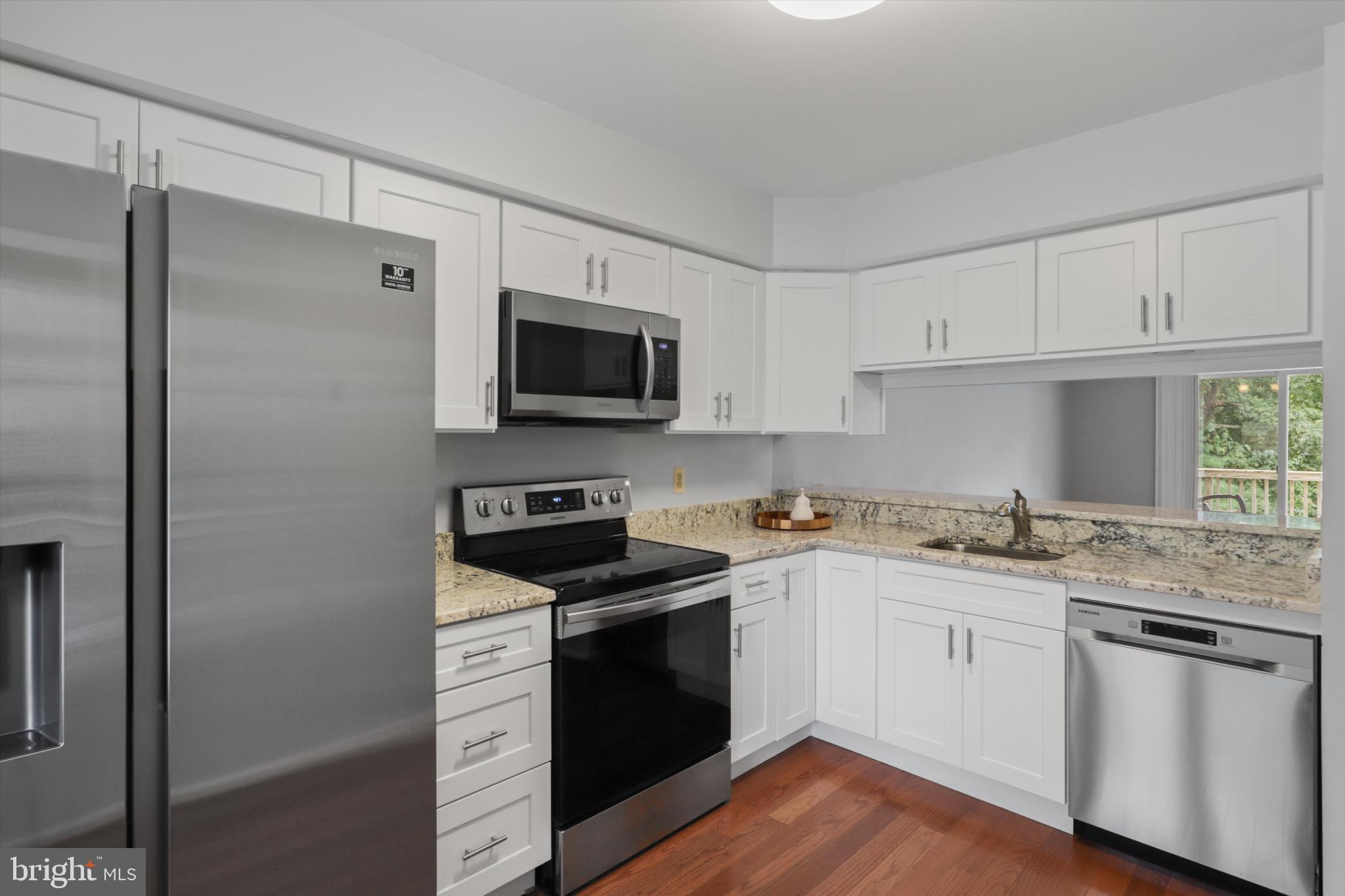 8564 Springfield Oaks Drive Springfield, VA 22153 - Photo 6 of 28 a kitchen with stainless steel appliances granite countertop a stove a sink and a refrigerator