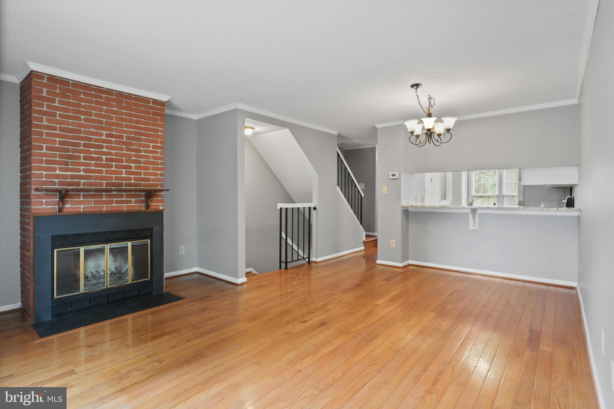 8564 Springfield Oaks Drive Springfield, VA 22153 - Photo 7 of 28 a view of empty room with wooden floor and fireplace