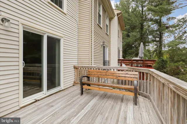 a view of backyard with deck and wooden floor