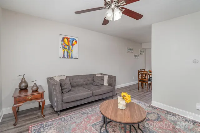 a living room with furniture and a lamp