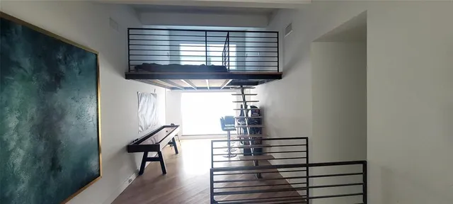a view of entryway and hall with wooden floor