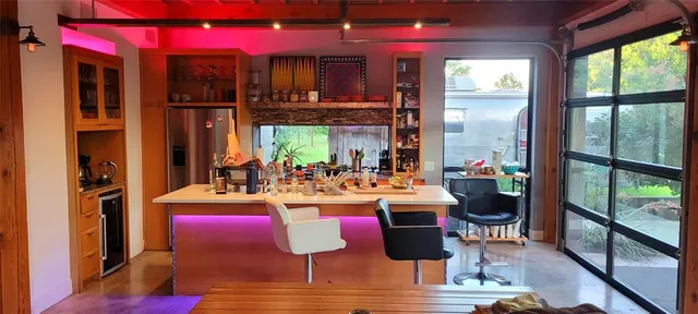 a room with lots of wooden furniture wooden floor and a chandelier