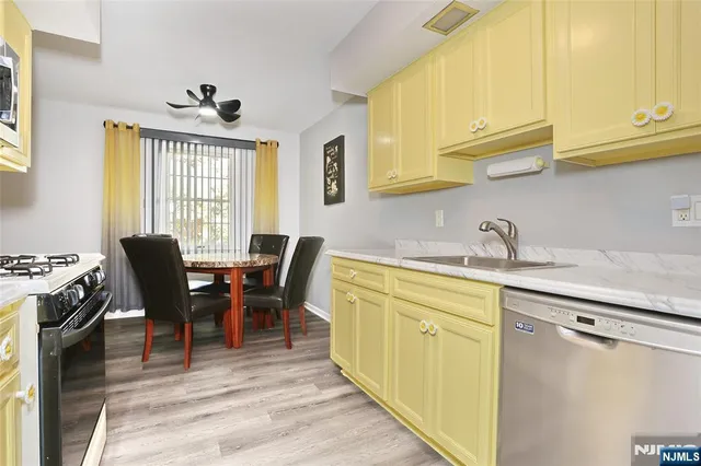 a view of a kitchen area with furniture and wooden floor