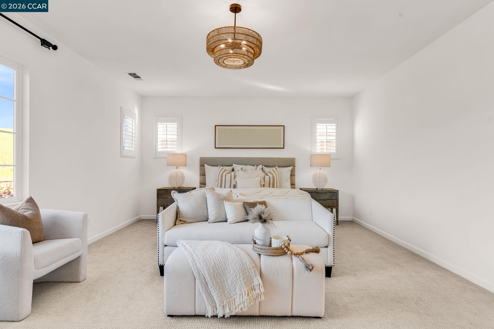 116 Spalding Court San Ramon, CA 94582 - Photo 28 of 59 a bedroom with a bed and a chandelier