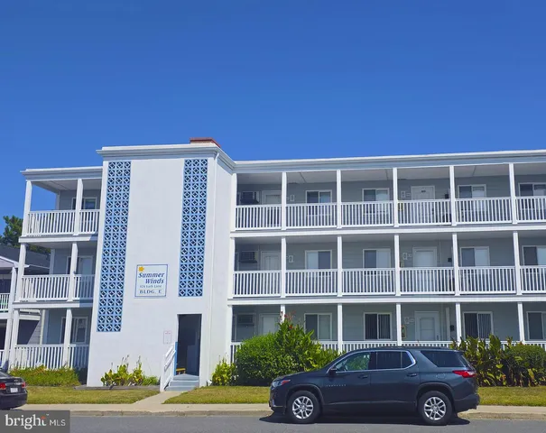 a front view of a building with parking space
