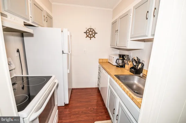 a stove top oven sitting inside of a kitchen