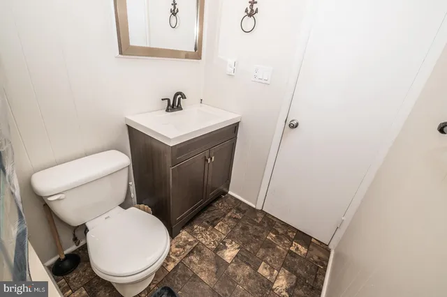 a bathroom with a shower a toilet and a window