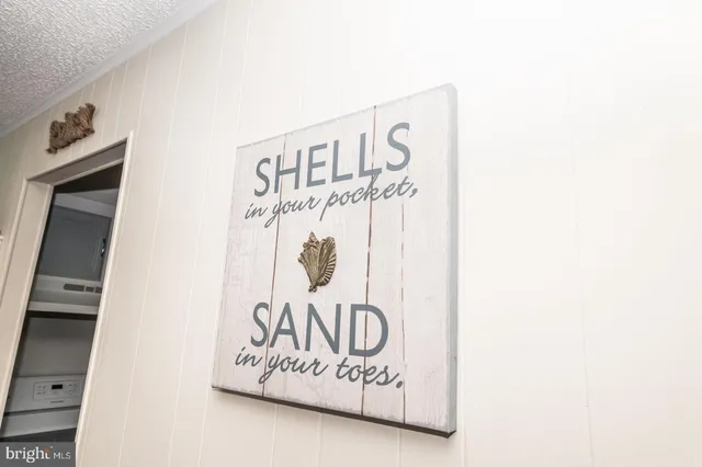 a kitchen with stainless steel appliances kitchen island granite countertop a sink and a white cabinets