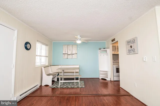 a living room with furniture a window and wooden floor