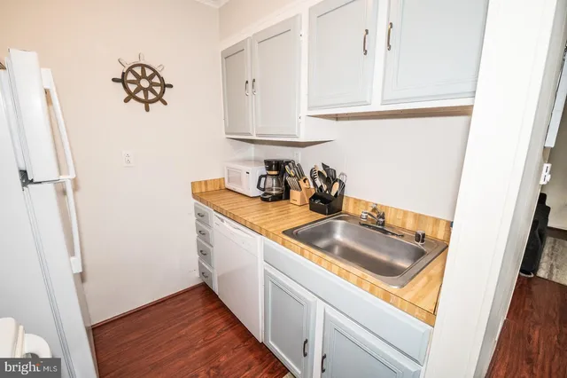 a view of a kitchen with appliances and wooden floor