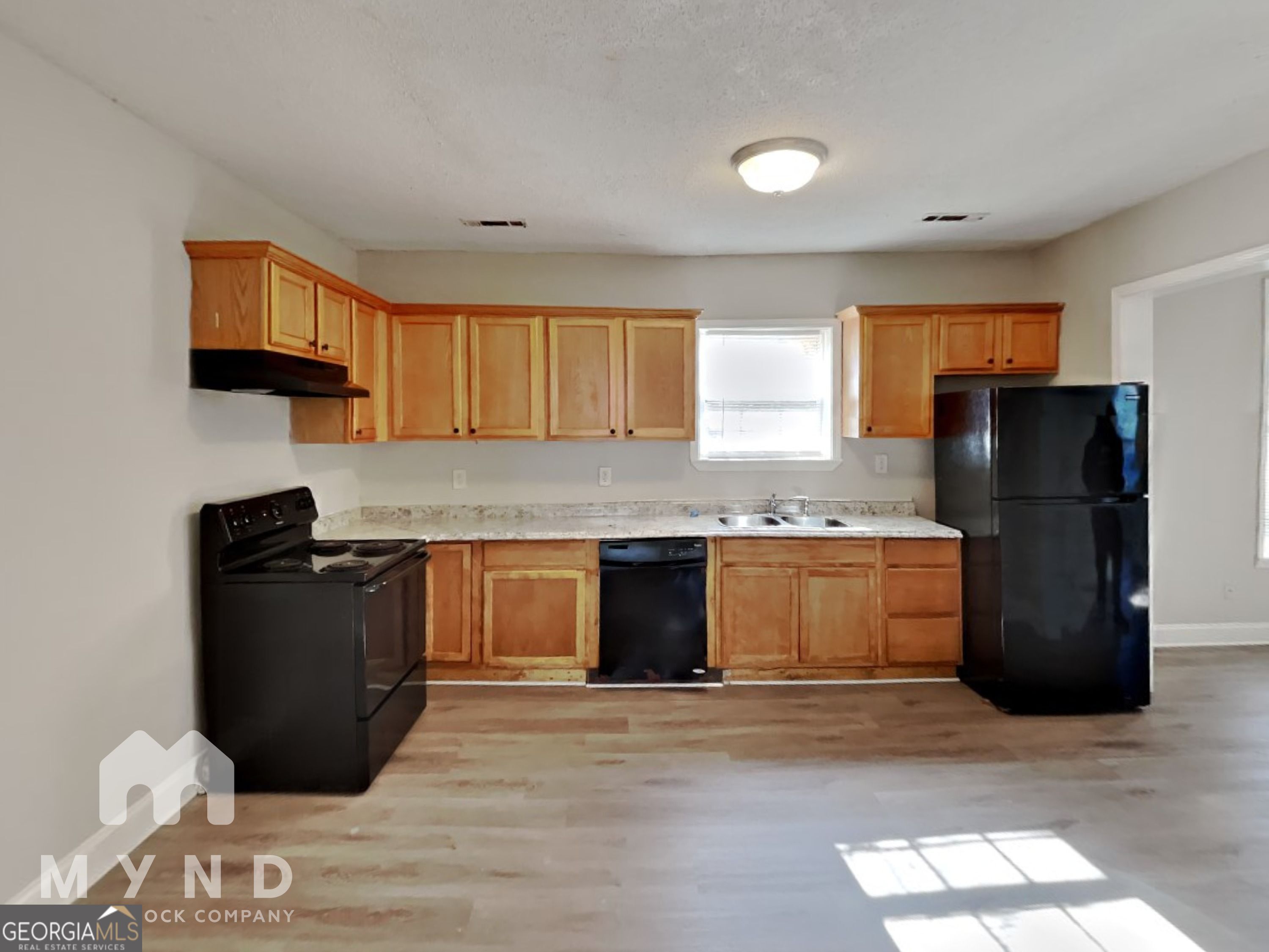 1708 Evans Drive Southwest Atlanta, GA 30310 - Photo 2 of 14 a kitchen with granite countertop a refrigerator and a stove top oven