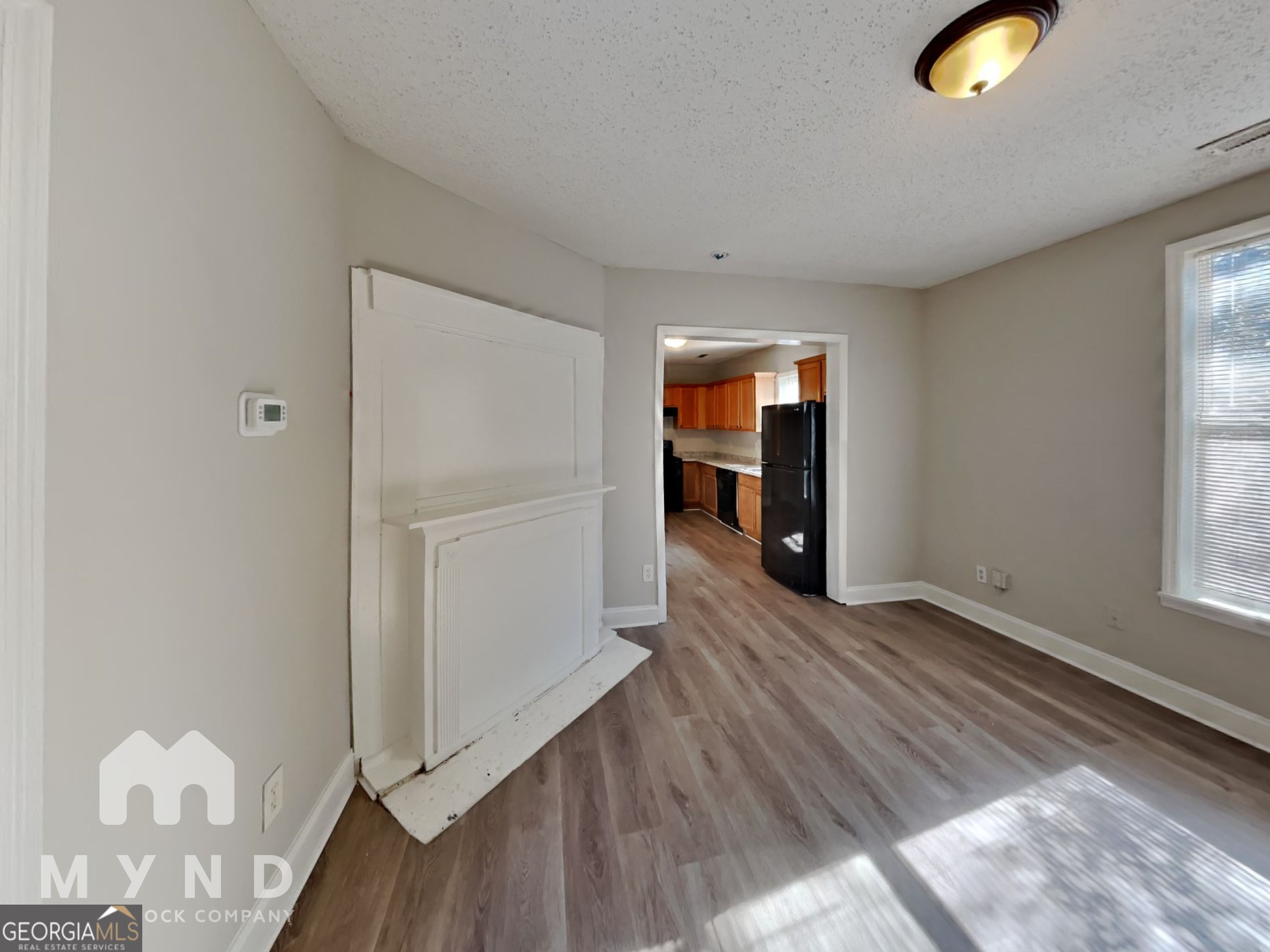 1708 Evans Drive Southwest Atlanta, GA 30310 - Photo 5 of 14 an empty room with wooden floor and windows