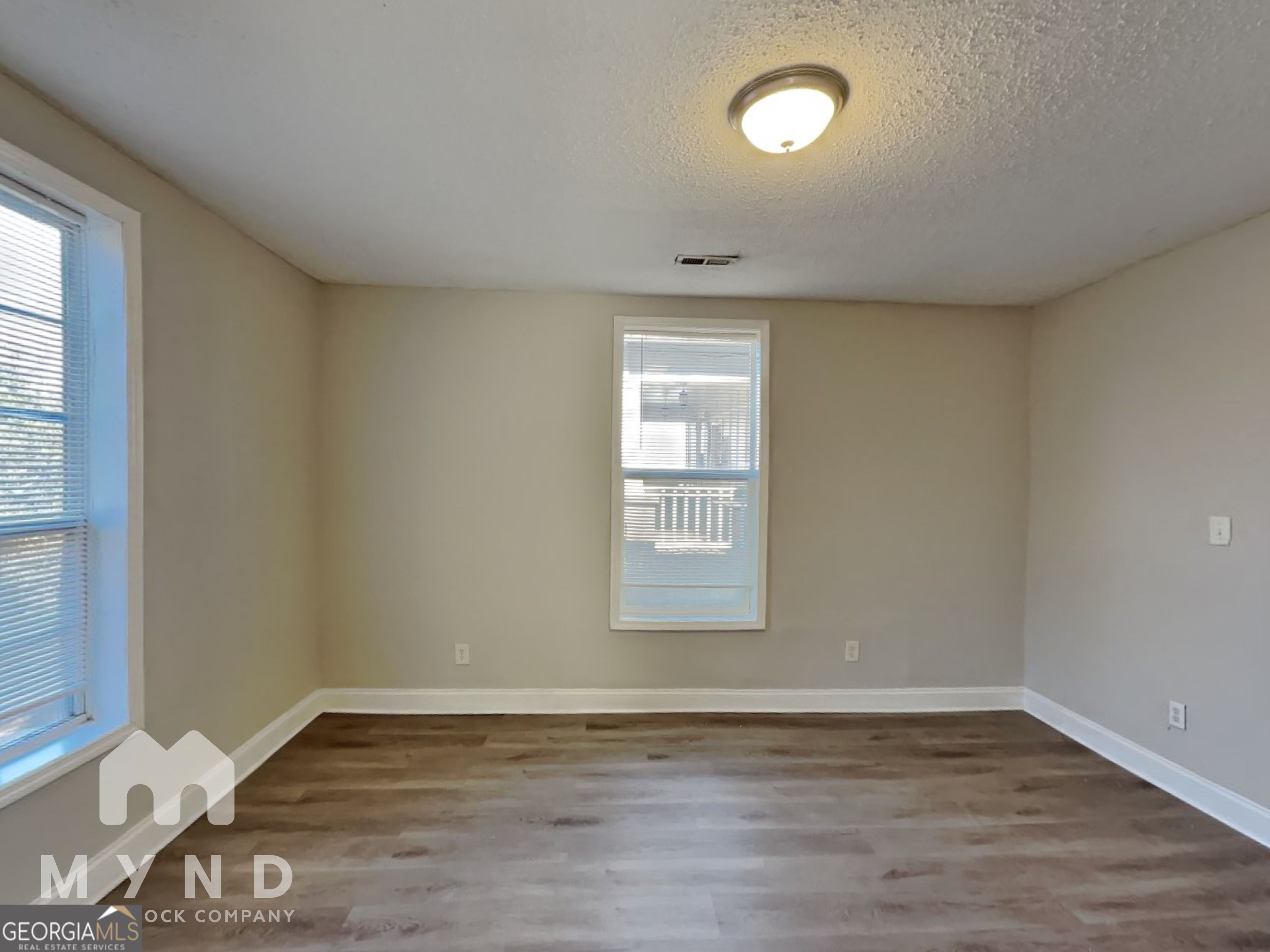 1708 Evans Drive Southwest Atlanta, GA 30310 - Photo 10 of 14 an empty room with wooden floor and windows