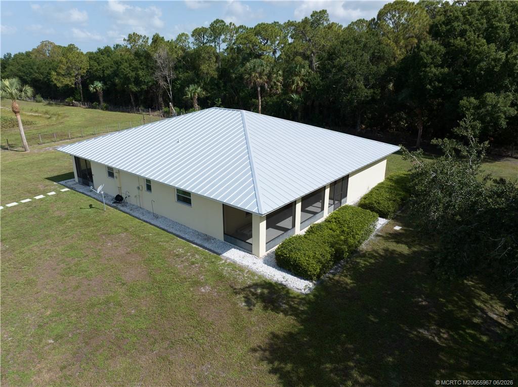 8200 Southwest Springhaven Avenue Indiantown, FL 34956 - Photo 7 of 35 a view of a big house with a big yard and large tree