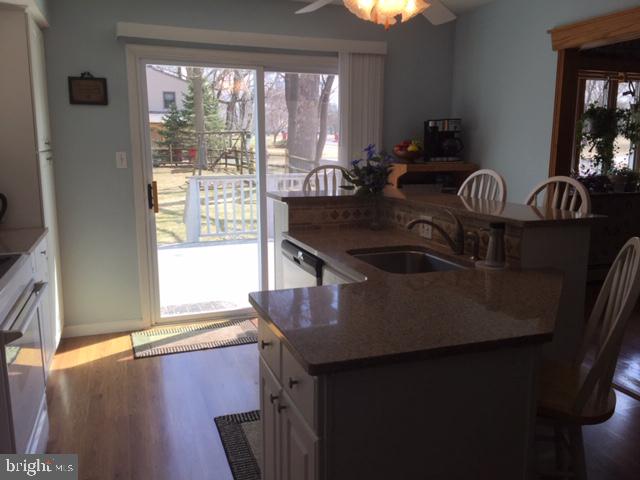 911 Lavera Road Warminster, PA 18974 - Photo 7 of 33 Kitchen island &breakfast bar with slider beyond.