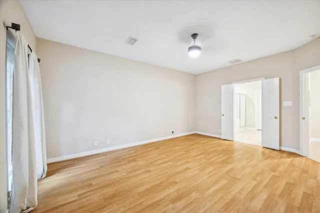 a spacious bathroom with a double vanity sink a large mirror and shower