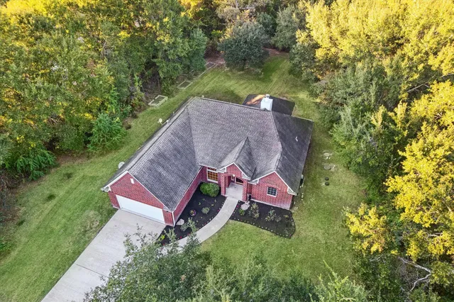 an aerial view of a house with a yard
