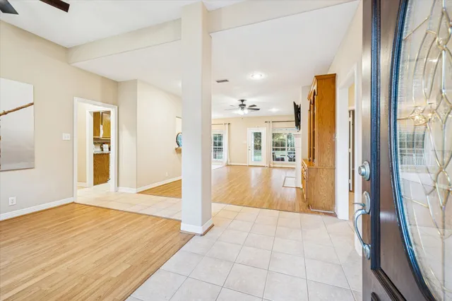 a view of an entryway with wooden floor and a livingroom
