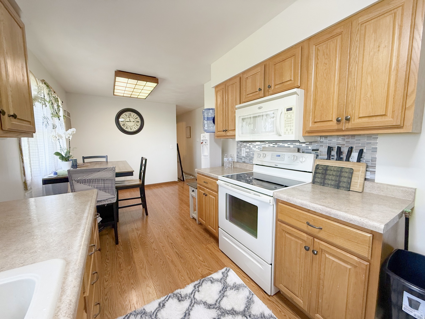 31535 East Thome Road Rock Falls, IL 61071 - Photo 12 of 31 a kitchen with a stove a refrigerator and a stove with wooden floor