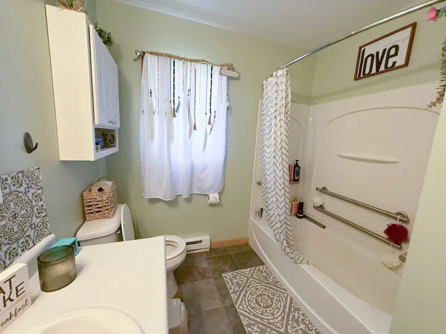 a bathroom with a bathtub and shower