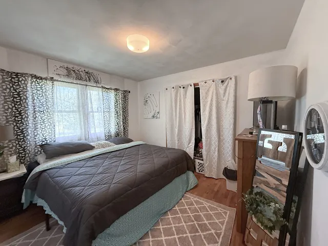 a bedroom with double bed and a window