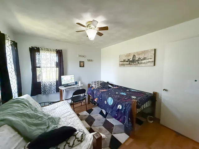 a bedroom with a bed and window