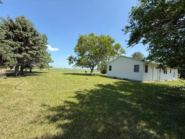a view of a house with a backyard