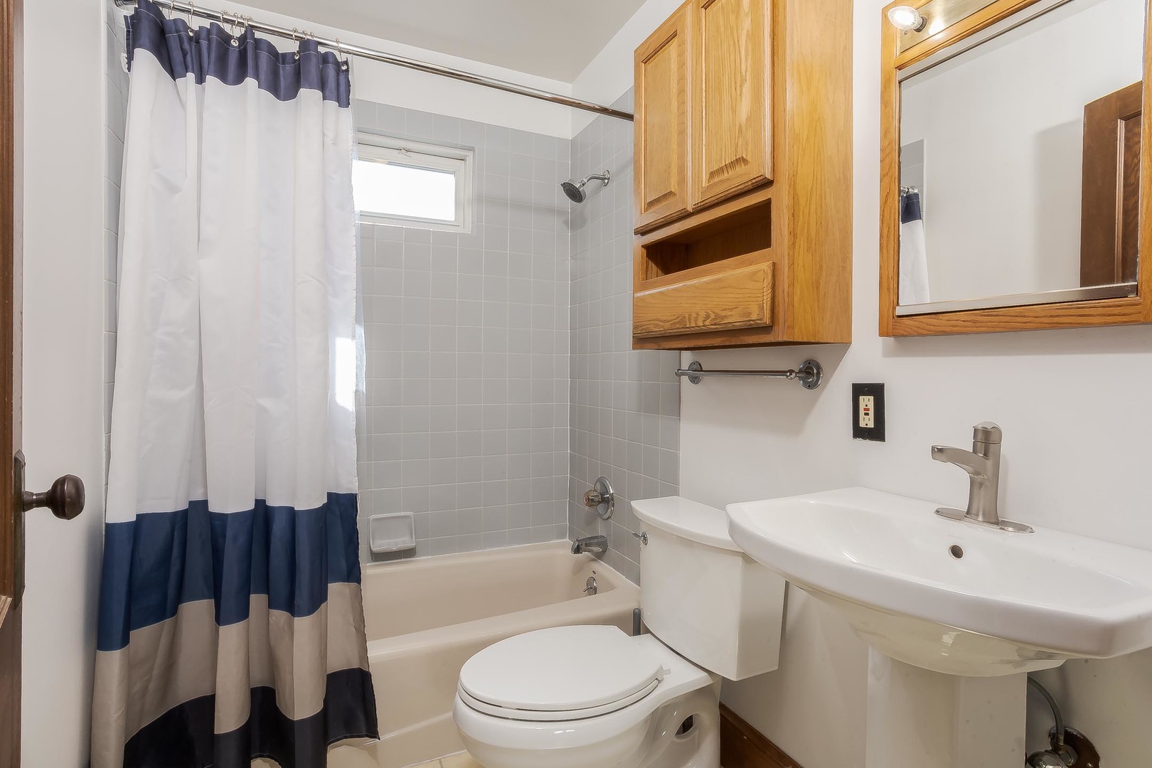 806 Normal Avenue Normal, IL 61761 - Photo 29 of 54 a bathroom with a sink toilet a mirror and shower
