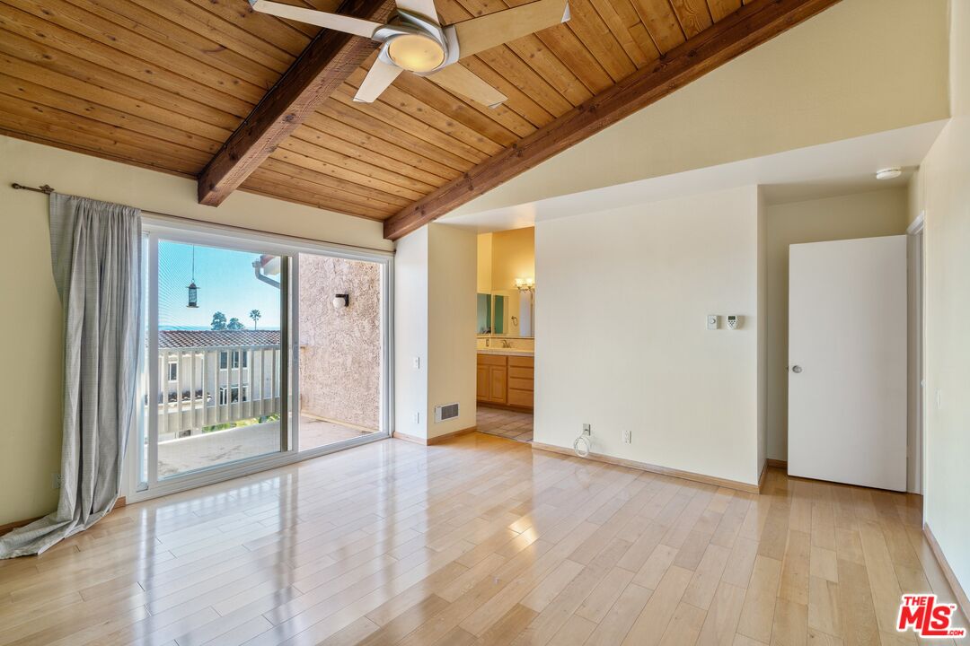 28244 Rey De Copas Lane Malibu, CA 90265 - Photo 14 of 31 a view of a hallway with wooden floor and a bathroom