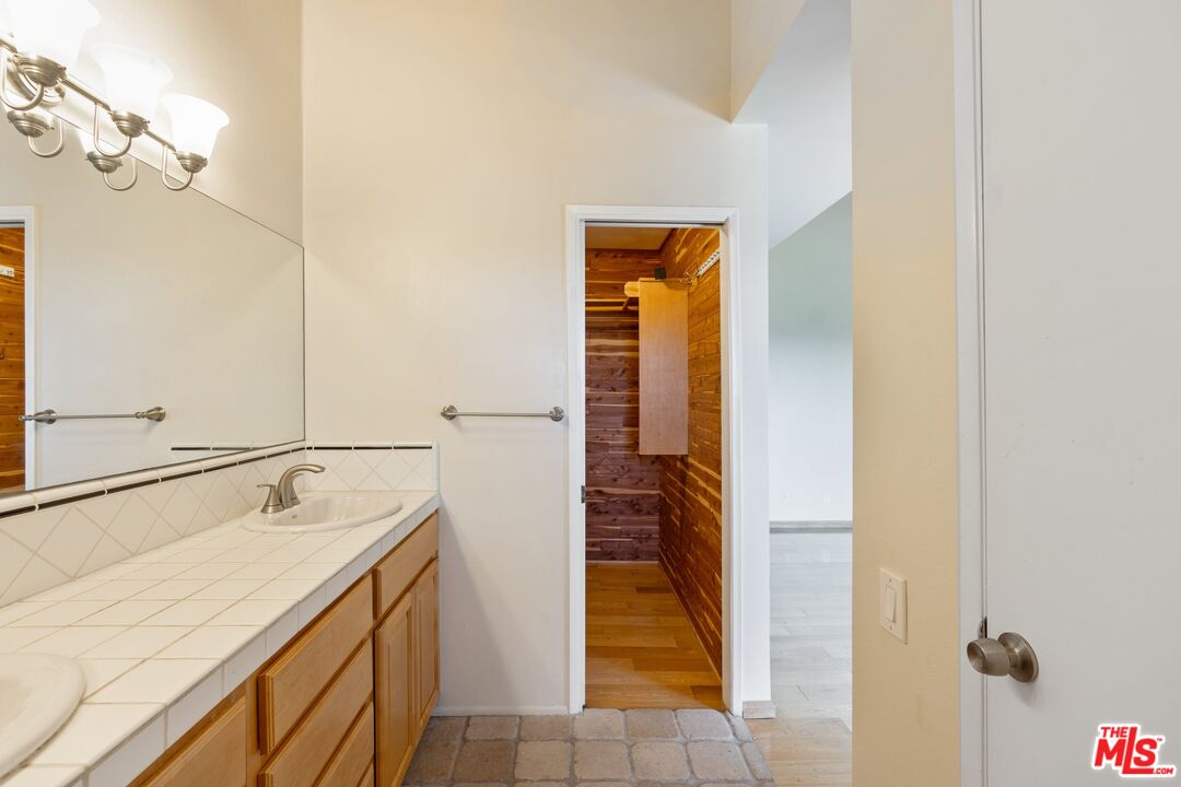 28244 Rey De Copas Lane Malibu, CA 90265 - Photo 18 of 31 a bathroom with a sink and a mirror