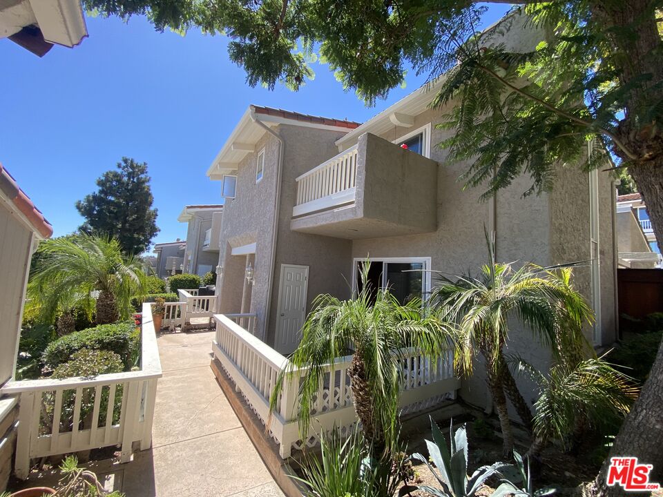 28244 Rey De Copas Lane Malibu, CA 90265 - Photo 2 of 31 a view of a house with fountain and potted plants
