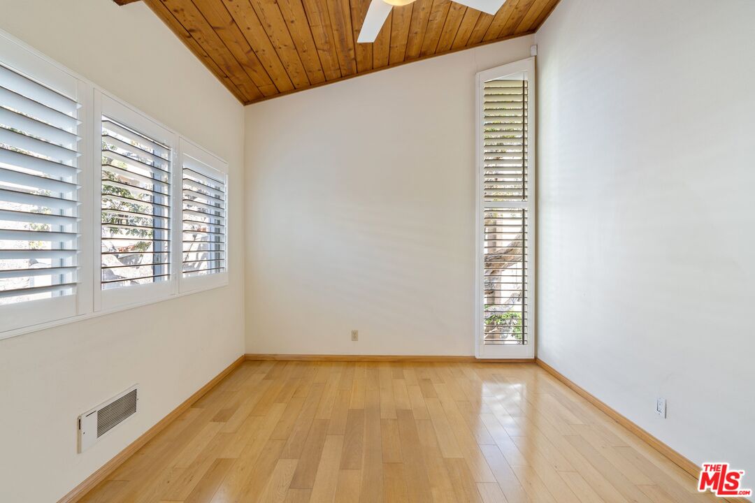 28244 Rey De Copas Lane Malibu, CA 90265 - Photo 21 of 31 a view of empty room with wooden floor and fan