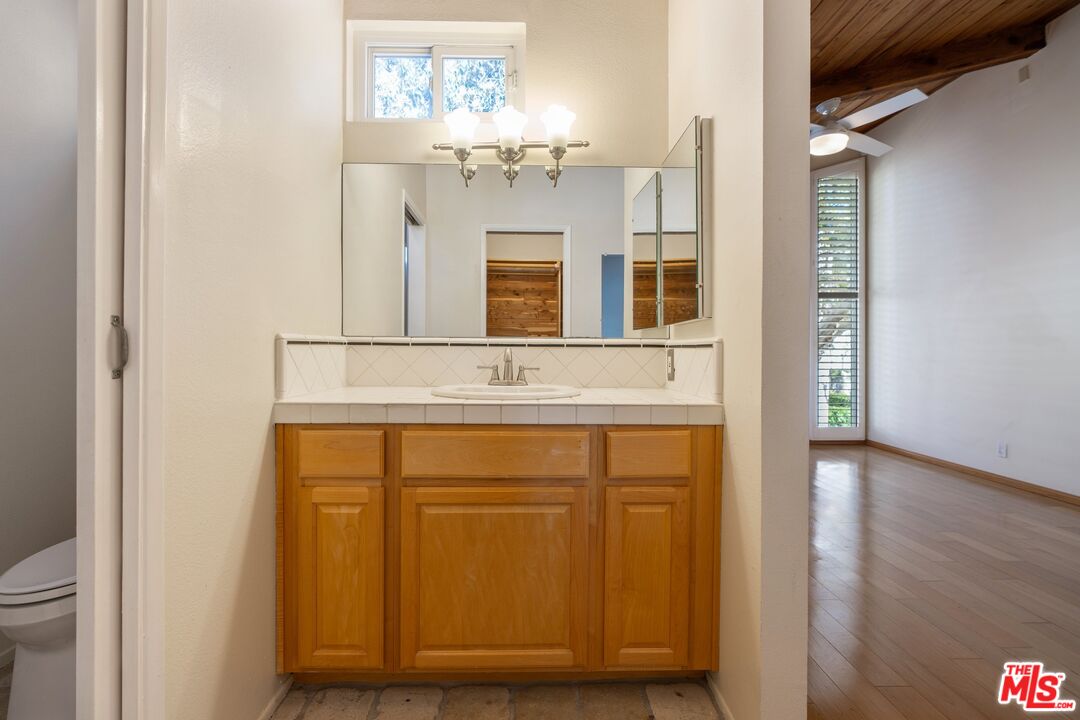 28244 Rey De Copas Lane Malibu, CA 90265 - Photo 22 of 31 a bathroom with a sink and a mirror