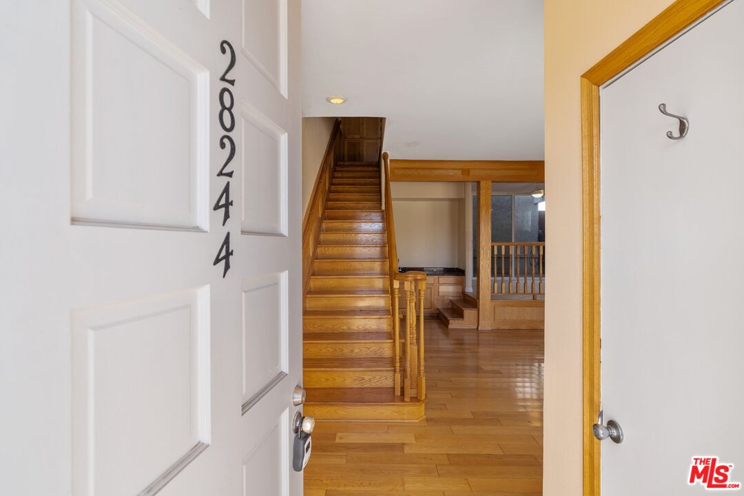 28244 Rey De Copas Lane Malibu, CA 90265 - Photo 3 of 31 a view of entryway and hall with wooden floor