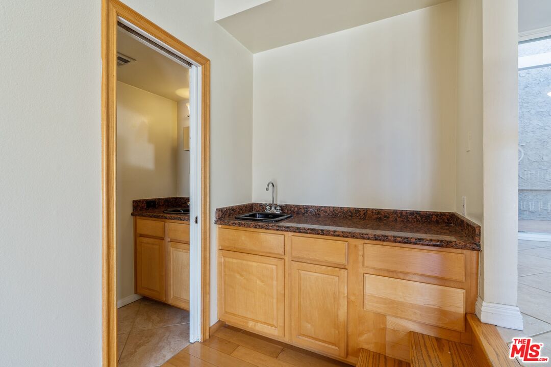 28244 Rey De Copas Lane Malibu, CA 90265 - Photo 7 of 31 a view of cabinets and wooden floor