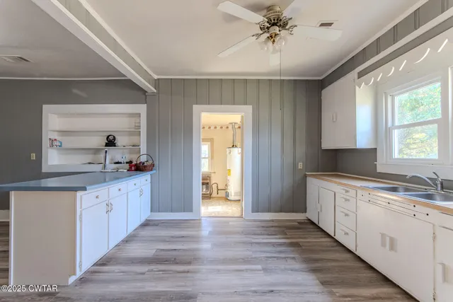 a large kitchen with a sink and dish washer