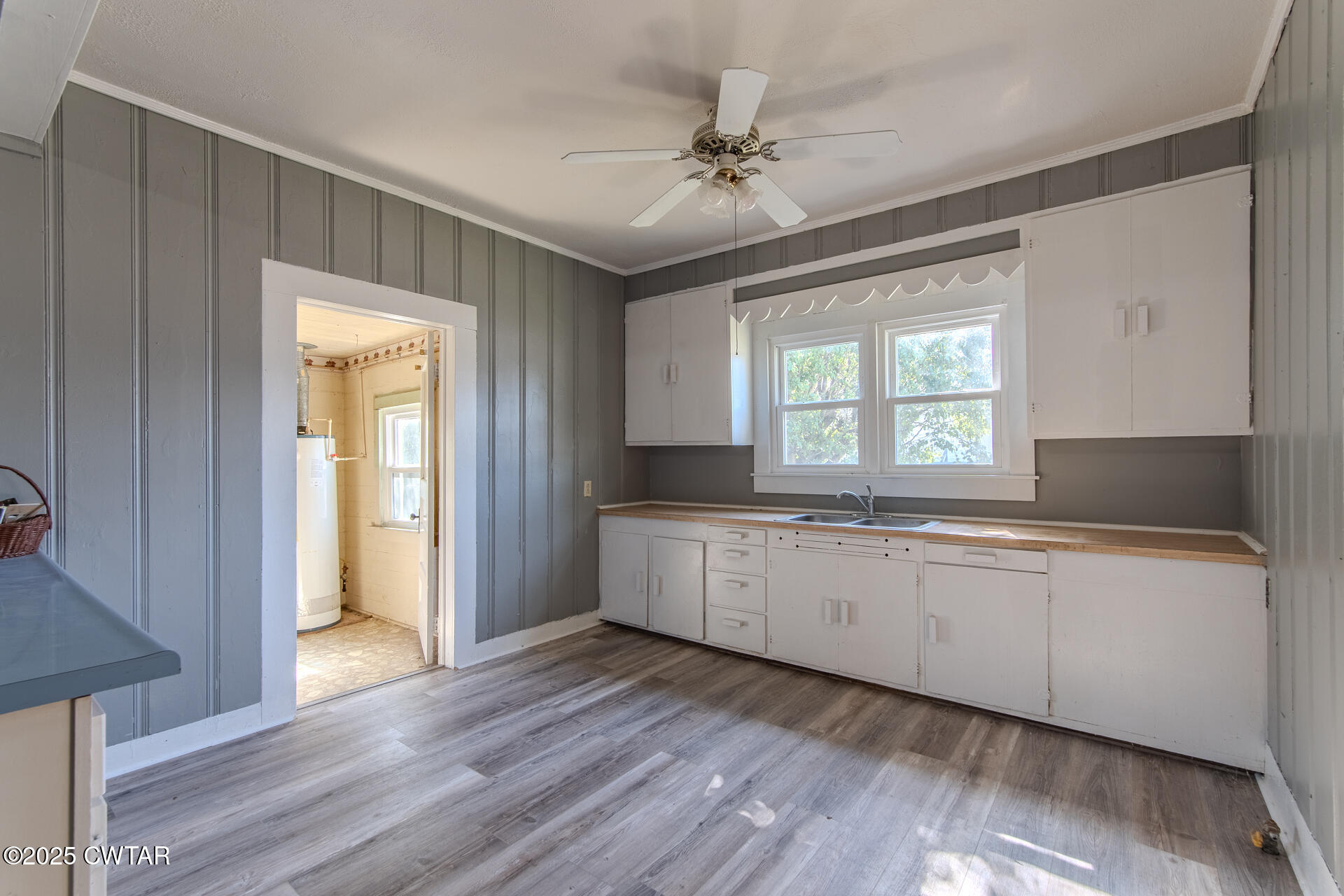101 North Front Street Kenton, TN 38233 - Photo 8 of 30 a large white kitchen with sink and dishwasher with wooden floor