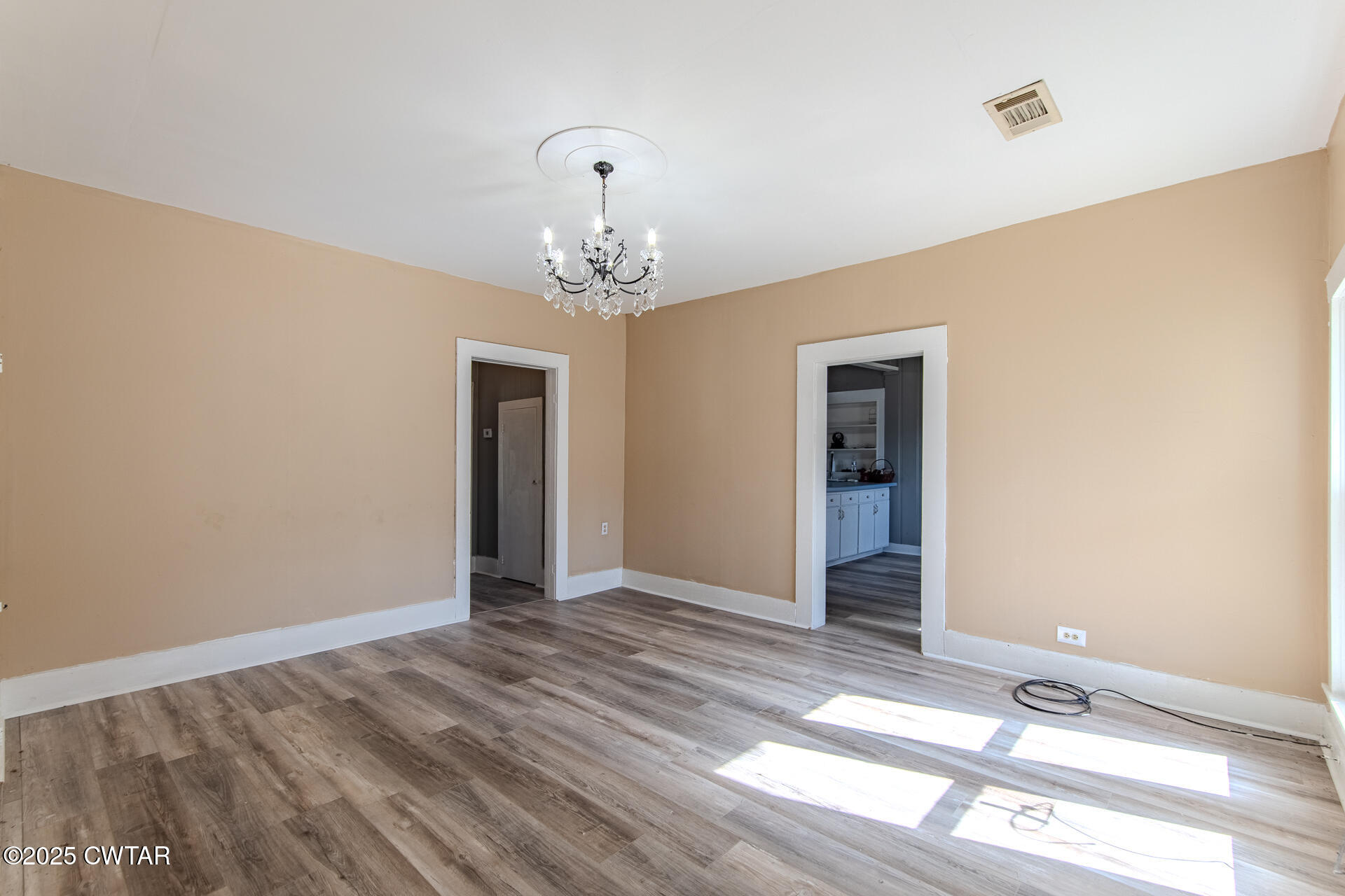 101 North Front Street Kenton, TN 38233 - Photo 10 of 30 a view of a room with wooden floor and chandelier