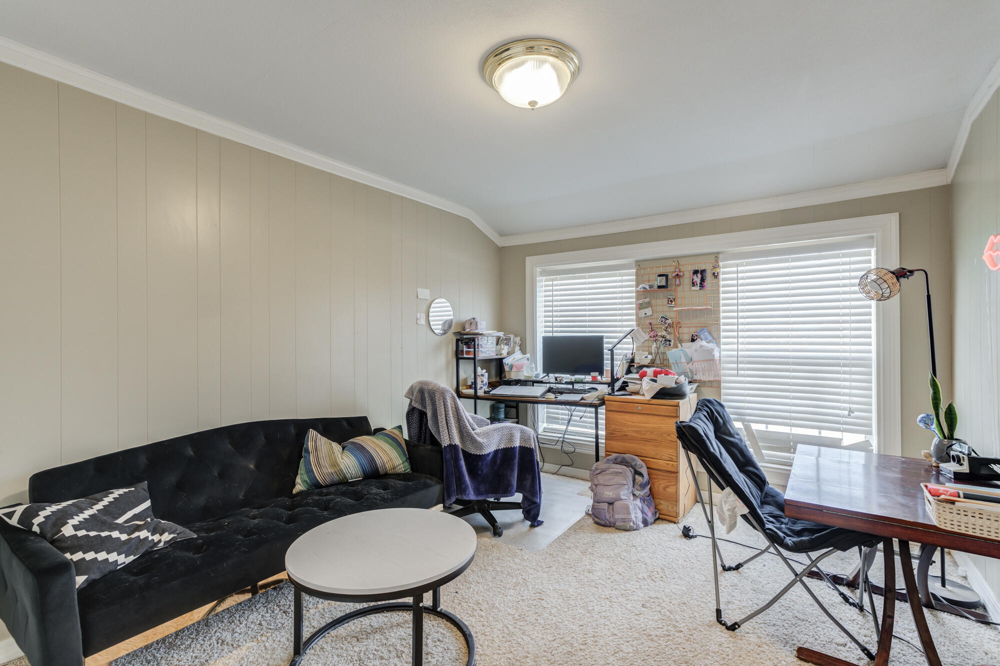 3315 25th Street Lubbock, TX 79410 - Photo 8 of 29 a living room with furniture a flat screen tv and a window
