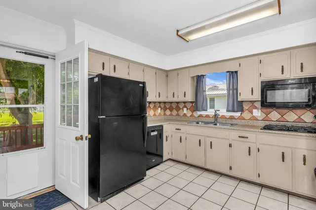 a kitchen with granite countertop cabinets and refrigerator