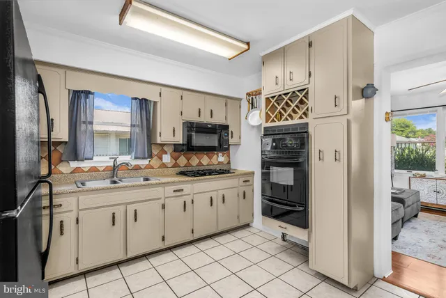 a kitchen with stainless steel appliances a refrigerator sink and microwave