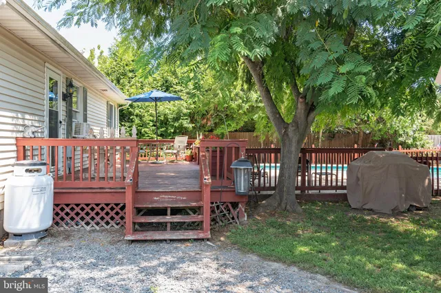 a wooden bench sitting in front of a house