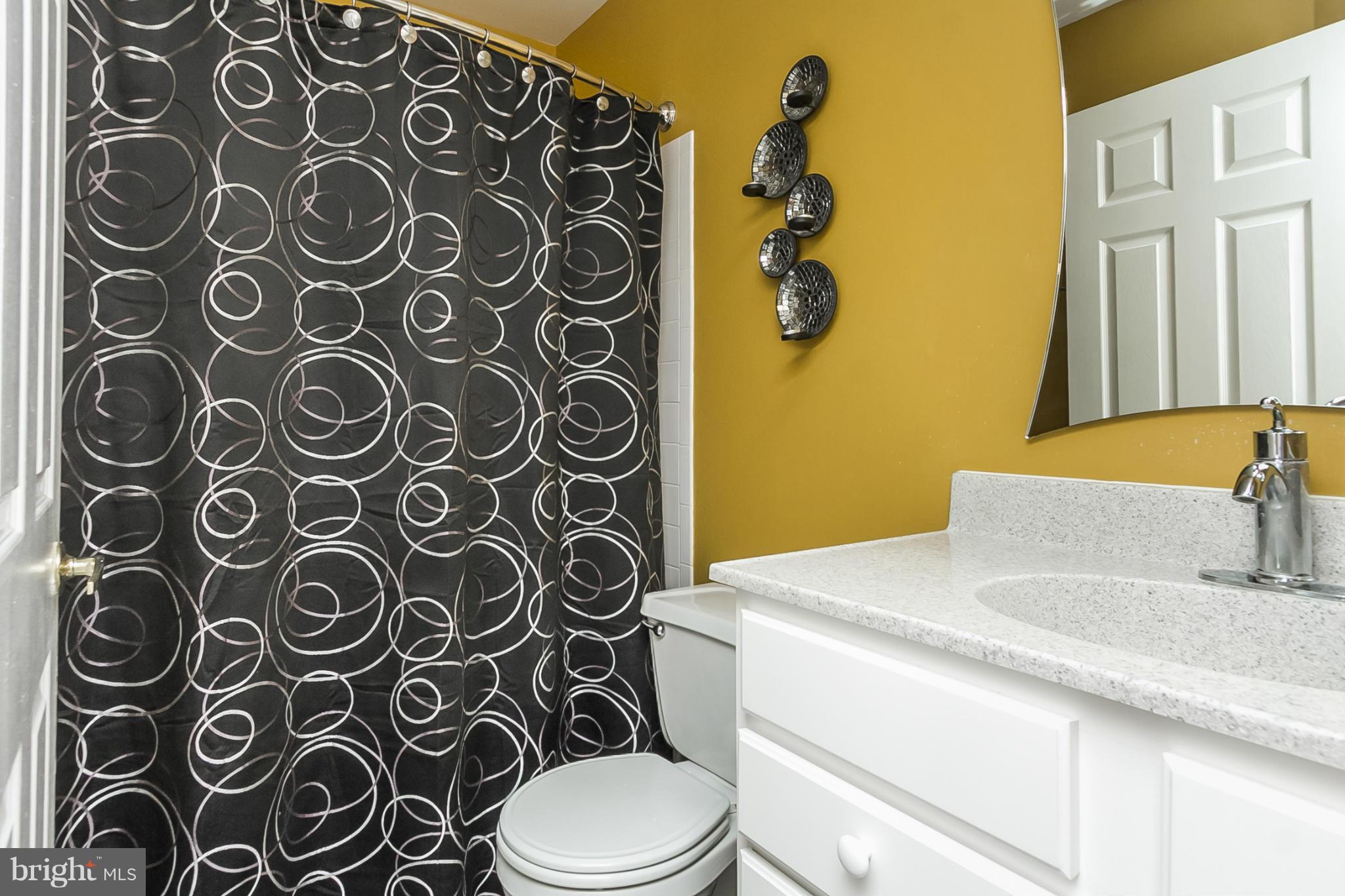 9108 Gardenia Road Baltimore, MD 21236 - Photo 22 of 26 a bathroom with a sink and mirror with toilet