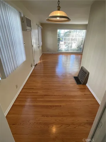 a kitchen with granite countertop wooden floors appliances and sink
