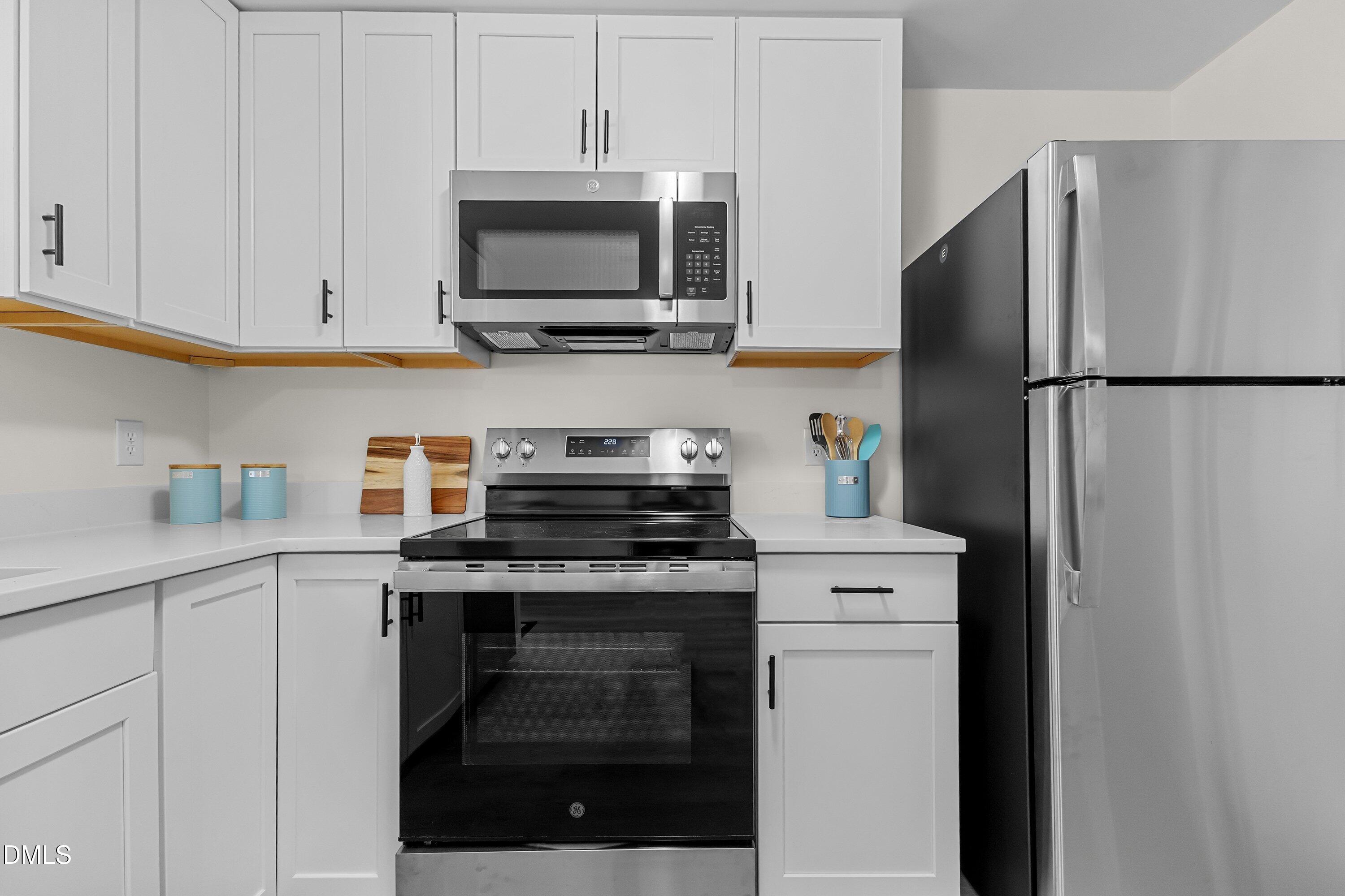 632 Middleton Avenue Cary, NC 27513 - Photo 16 of 34 a kitchen with stainless steel appliances white cabinets and a refrigerator