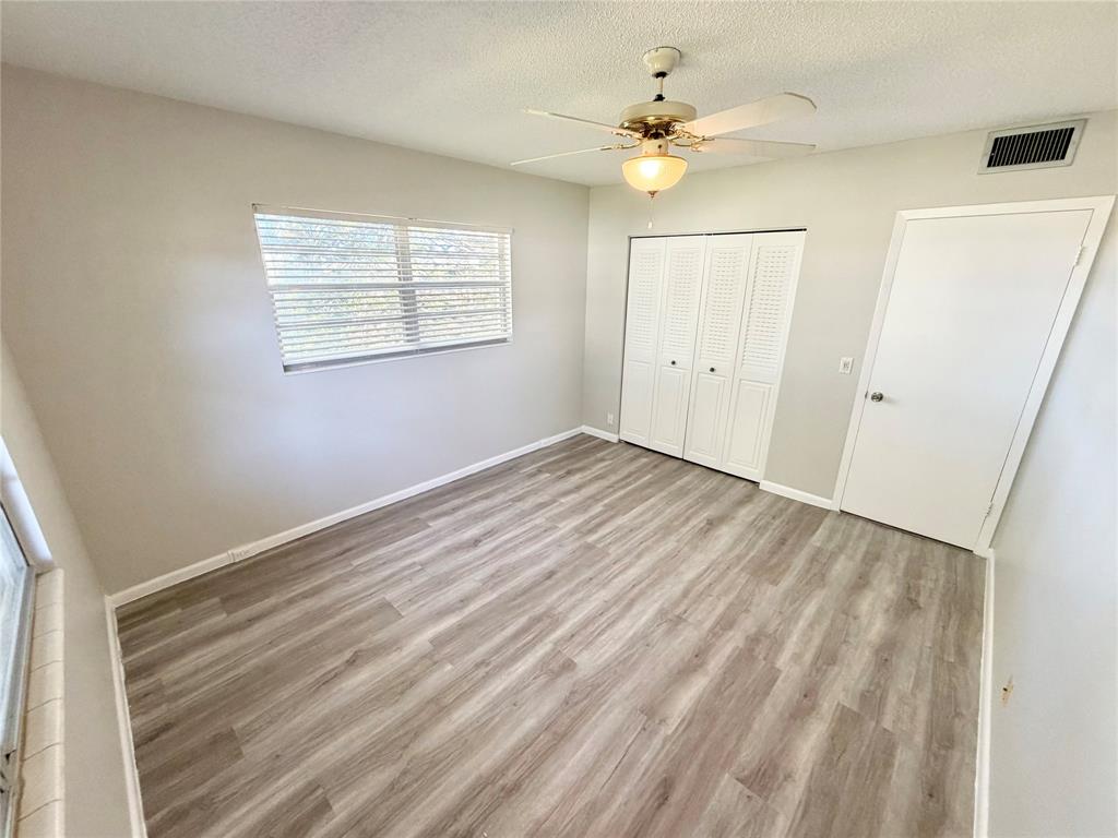 84 Mansfield A, Unit 84 Boca Raton, FL 33434 - Photo 11 of 24 an empty room with windows and fan