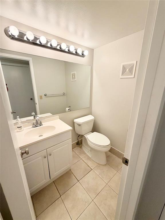 84 Mansfield A, Unit 84 Boca Raton, FL 33434 - Photo 16 of 24 a bathroom with a toilet a sink and mirror