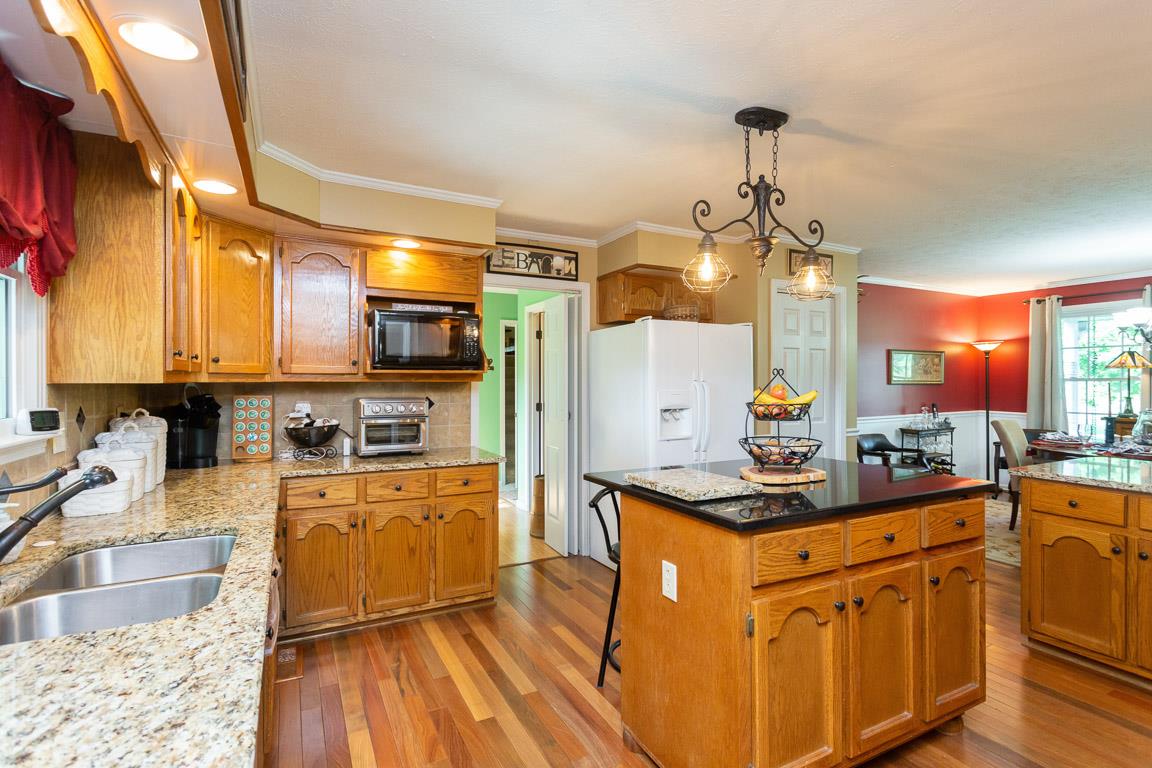 2120 Cairo Bend Road Lebanon, TN 37087 - Photo 11 of 30 a kitchen with granite countertop a sink stove and refrigerator