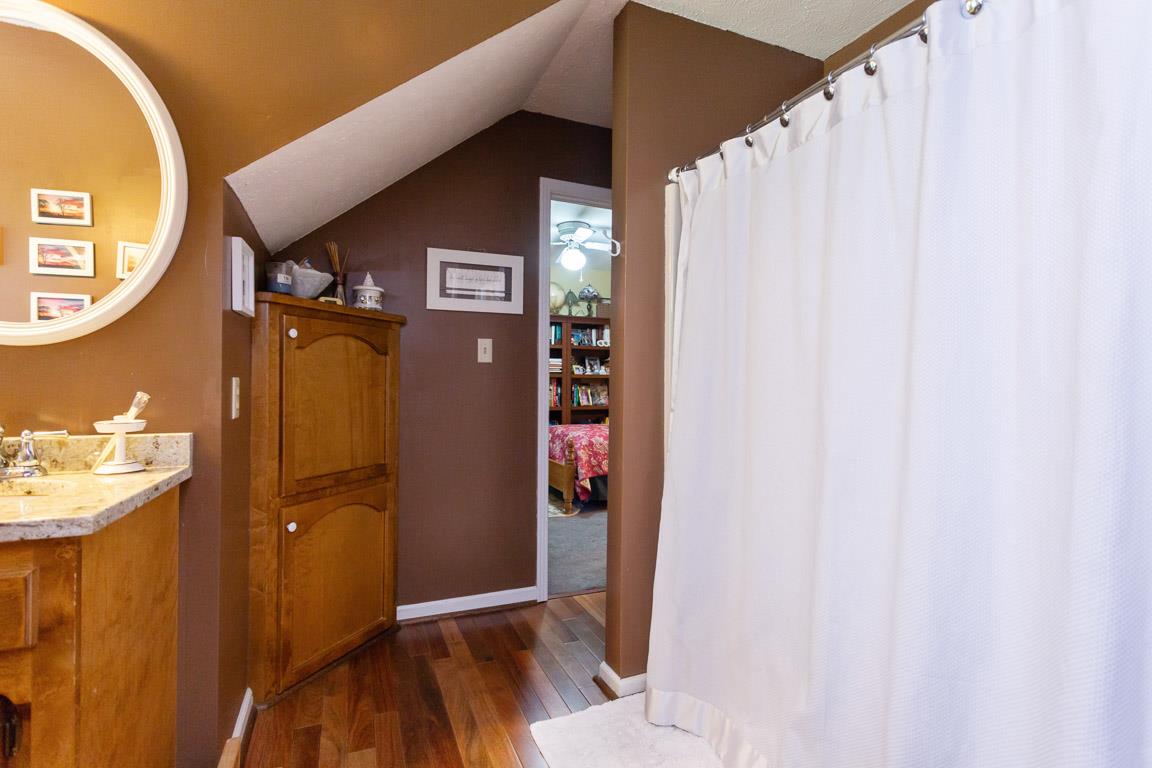 2120 Cairo Bend Road Lebanon, TN 37087 - Photo 21 of 30 a view of a hallway with wooden floor and a bathroom